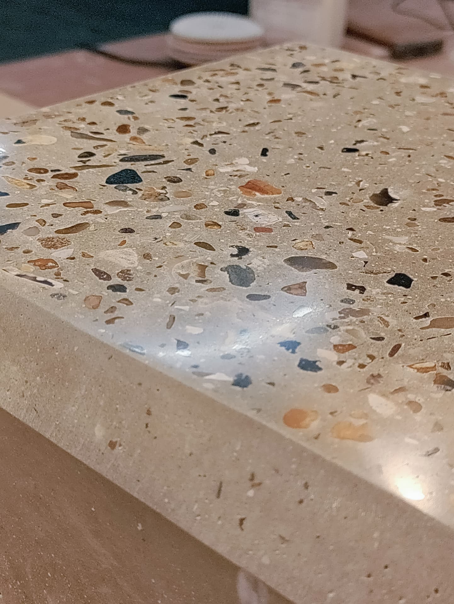 Hand-polished terrazzo edge of a cast concrete counter