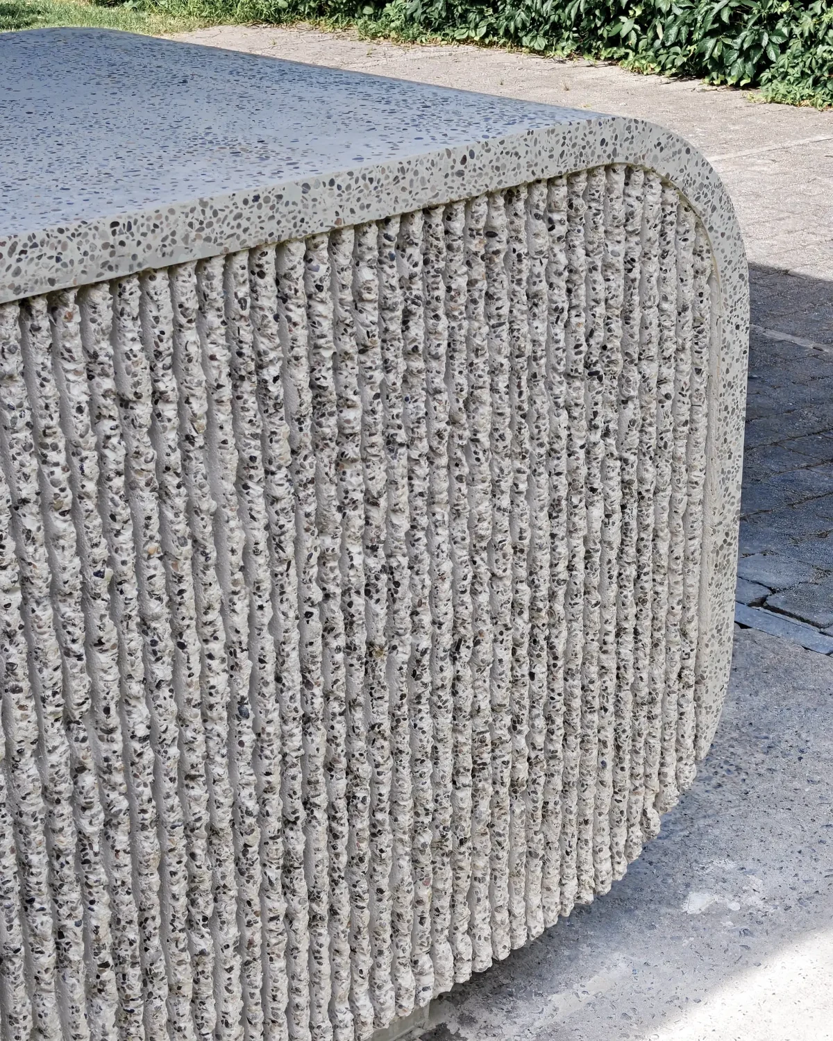 The ribbed concrete face meeting the polished terrazzo top of ISF 002